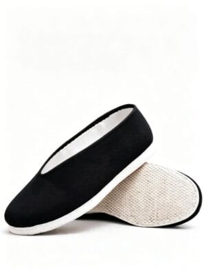LUNO LN-M3010 men's traditional Chinese round-toe kung fu shoes side-and-sole view - featuring a classic black fabric upper with clean stitching along the toe and collar, a smooth white rubber sole with subtle tread for grip, and a slip-on design that emphasizes comfort and ease of wear; the unlined interior suggests breathability, making it ideal for casual daily use or martial arts practice in warm weather.