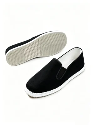 LUNO LN-M4002 men's traditional handmade cloth shoes with anti-slip pads - angled side view showcasing the sleek black upper, white stitching along the edge, and the textured white rubber sole designed for enhanced grip; the minimalist slip-on style combines heritage craftsmanship with modern functionality, ideal for casual daily wear.