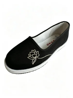 Side-angle view of LUNO LN-W4033 women's cloth shoes - featuring black canvas upper with white lotus embroidery, white rubber sole, and matching insole design for cultural elegance and everyday comfort.